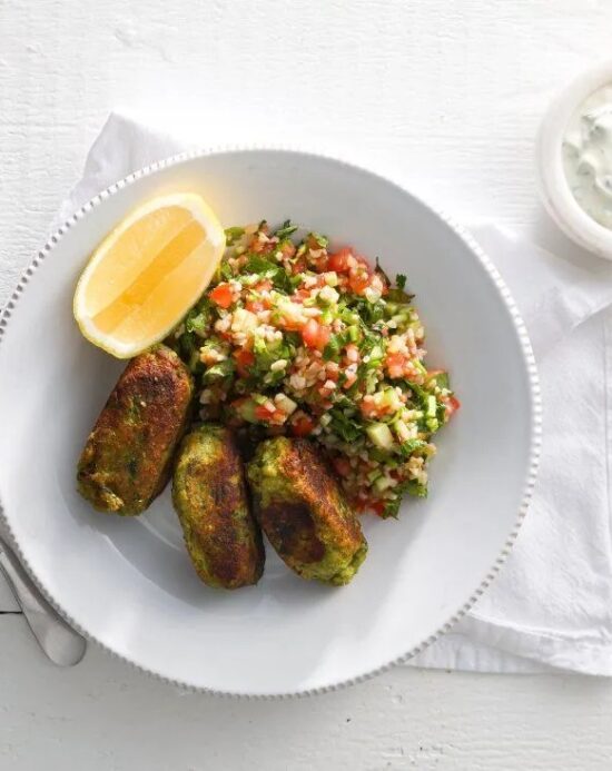 A vibrant vegetarian dish with spiced veggie koftas, fluffy couscous, roasted vegetables, and a tangy-sweet chilli yogurt dip for a balanced, flavorful bite.